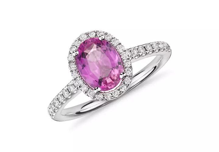 A pink sapphire and pave diamond engagement ring in white gold